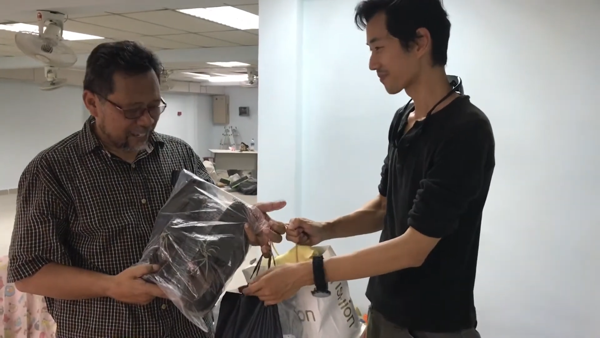 Impact Trails Asia team handing over supplies to a community partner